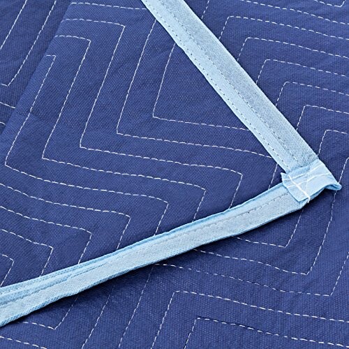 Close-up of a blue moving blanket with zigzag stitching and light blue trim.