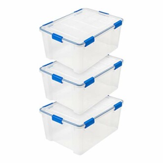 Three stacked clear plastic storage boxes with blue handles.